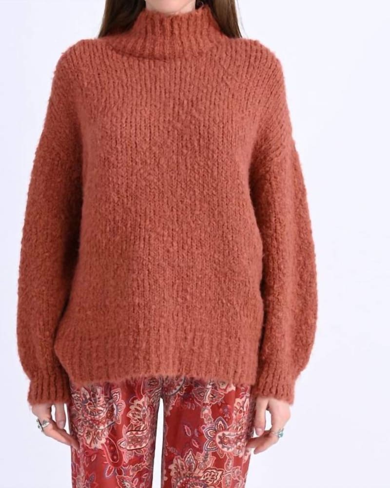 Front of a model wearing a size Large Soft Cable Knit Turtleneck Sweater in Terracotta in Terracotta by MOLLY BRACKEN. | dia_product_style_image_id:343702